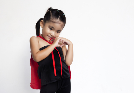 funny action of asian girl with black dress and red shawl make hand like heart symbol on white backgroundの写真素材