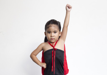 funny action of asian girl with black dress and red shawl in hero wonder concept on white backgroundの写真素材