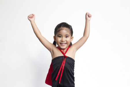 funny action of asian girl with black dress and red shawl in hero wonder concept on white backgroundの写真素材