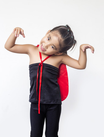 funny action of asian girl with black dress and red shawl in halloween or hero concept on white backgroundの写真素材