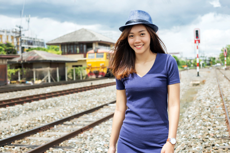 portrait street photo shot of asian lady at old train bogies in fashion conceptの写真素材