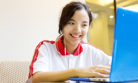 asian girl in digital generation using laptop for communication social online front of building or...