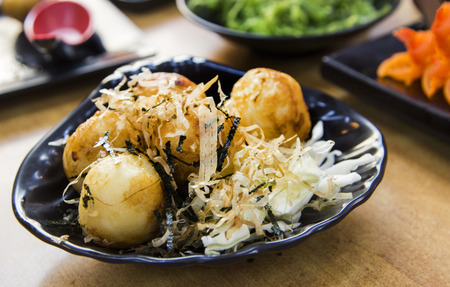 close up ball with squid inside toast call Takoyaki japanese food menu on tableの写真素材