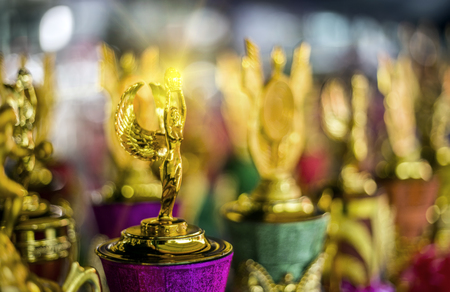 select focus shining tropy angel in gold color to reward winner in competitionの写真素材