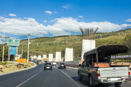 24 December 2017,Nakornrachasima,Thailand : Construct high way bridge to northern of Thailand at Nakornrachasima Province and wind turbine power on mountain as innovation conceptのeditorial素材