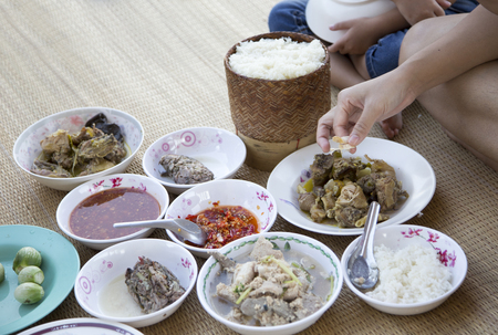 mix menu Northeastern Thai food style on rattan mat from top view with sticky rice in agriculture lifestyleの写真素材