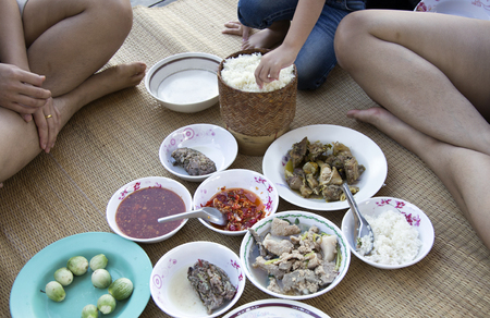 mix menu Northeastern Thai food style on rattan mat from top view with sticky rice in agriculture lifestyleの写真素材