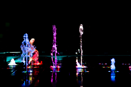 abstract art from fountain water with LED light in dark backgroundの写真素材
