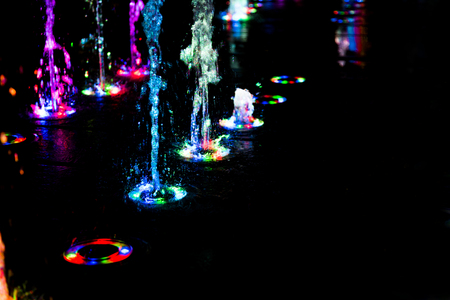 abstract art from fountain water with LED light in dark backgroundの写真素材
