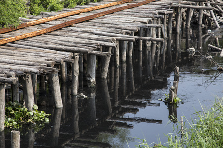 wood bridge cross the waste water in river , bad environtment conceptの写真素材