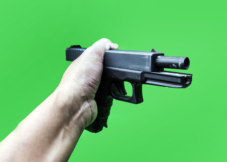 hand hold short gun with fabric to detect evidance of murder process on green isolate backgroundの写真素材