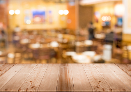 wood table top for display product with blur restaurant at backgroundの写真素材