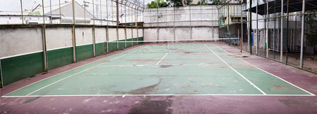 old and dirty tennis court for practice at homeの写真素材