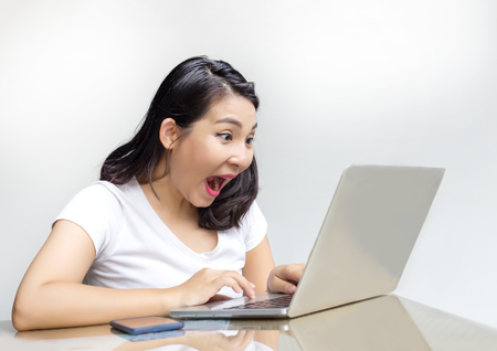 asian woman chock action watching on laptop の写真素材