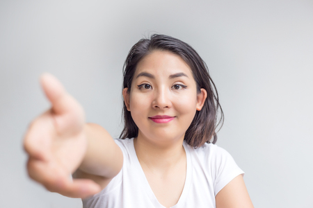 focus friendly face girl and give hand to chake for deal actionの写真素材