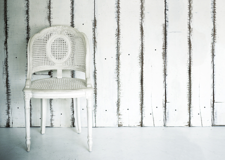 white vintage rattan chair victorian style on white wood wall interior designの写真素材