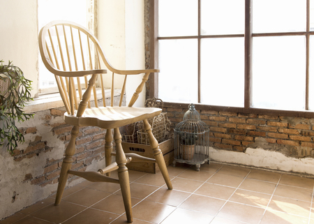 old wood chair vintage at indoor balcony with romantic morning warm lightの写真素材