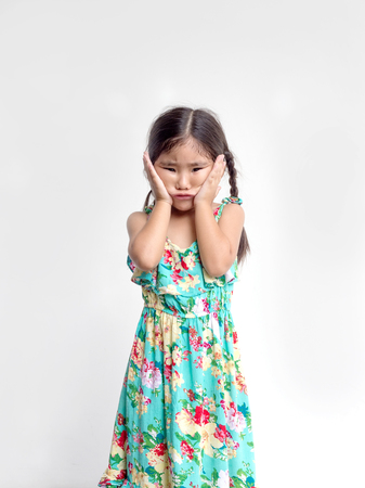 cute asian kids girl play funny face action on white backgroundの写真素材