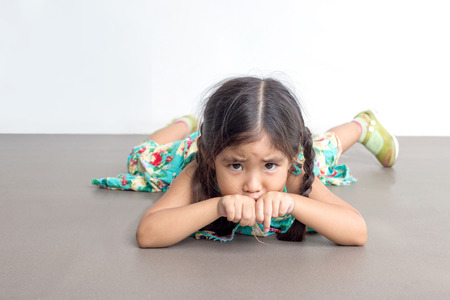 asian girl play funny action with her pony hair on white backgroundの写真素材