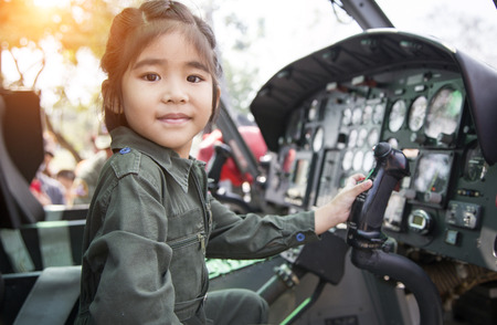 asian girl hanging helicopter control to catch up her dream to be a pilot jobsの写真素材