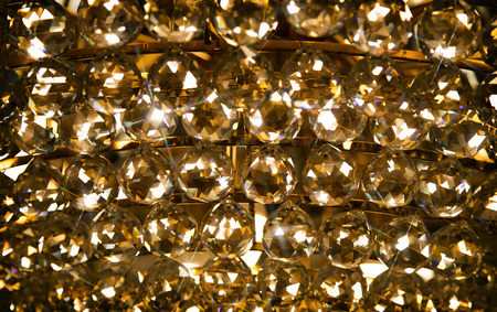 shining luxury crystal ball in chandelier in dark background for interior living roomの写真素材