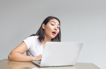 asian girl exciting action with laptop on table. People have emoton in digital object concept  の写真素材