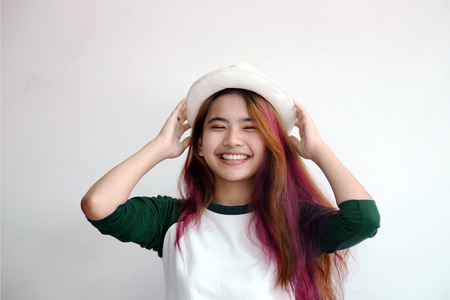 pretty asian femele smiling joyfully with colorful hair in dressed casually like hipster lifestyle,...