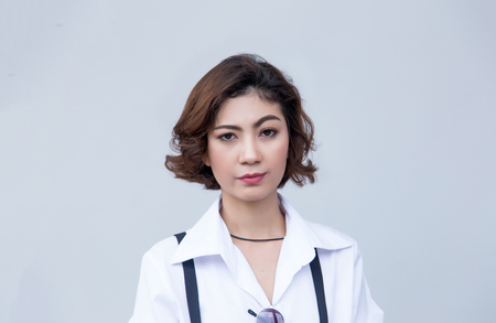 close up confidence action on face of asian lady on background. Pretty lady with curry short hair.の写真素材