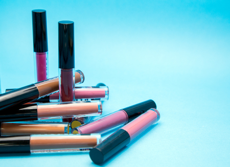 close up lipsticks matte color on blue background with space for text from top view. shade of Lipstick colour background.の写真素材