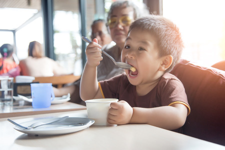 happy grandson live together in launch time. Happy family concept.の写真素材