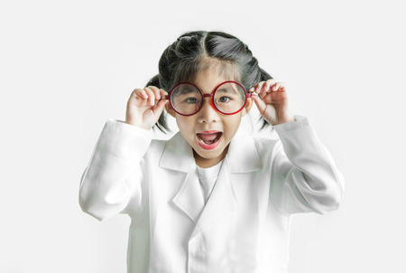 asian girl with big glasses and science suite action on white screen. touch glasses Action kid model with doctor or science costume.の写真素材