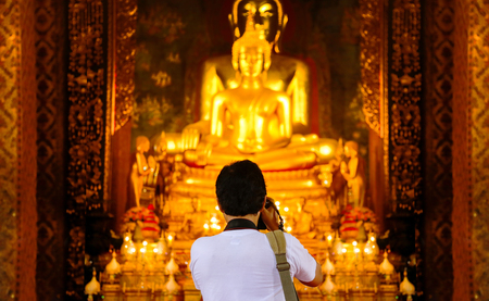 backyard of photographer capture gold buddha figure in Thailand temple. Beauty in religionの写真素材