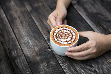 late coffee in mug on wood table in the morning time from top viewの写真素材