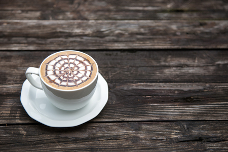 late coffee in mug on wood table in the morning time from top viewの写真素材