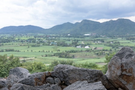 focus stone mountain and blur rural on backgroundの写真素材