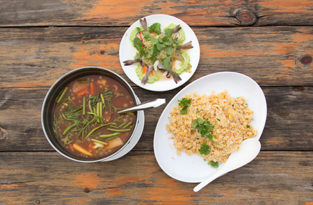 Thai cusine menu from top view on wood table for dinner. Thai food good health with herb and vegetableの写真素材