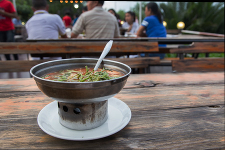 hot Curry orange soup with fish and Mesmerize vegetable Thai food menu in iron pot for dinner party. a famous Thai food, good heat food from herb vegetableの写真素材