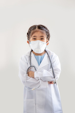 asian kids with air polution protect mask and stethoscope with  doctor suite costume. Portrait action as block smoke smell on blue background (include clipping path)の写真素材
