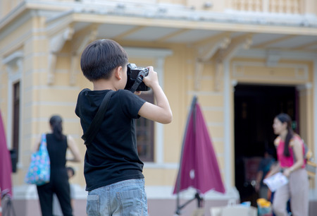 find talent of kids with real practice as  boy take photo with camera to improve skill.の写真素材