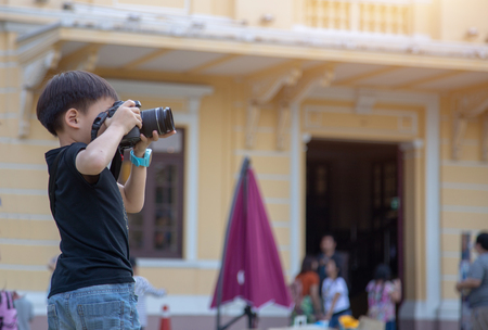 find talent of kids with real practice as  boy take photo with camera to improve skill.の写真素材