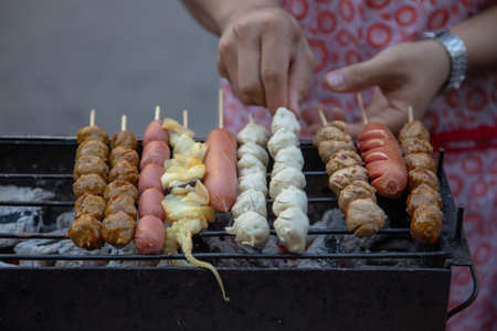 grill meat balls and squid with stick the famous street food of Thailand.の写真素材