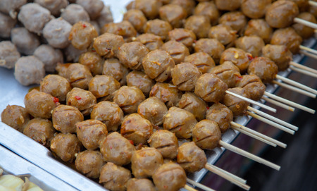 grill meat balls with stick the famous street food of Thailand.