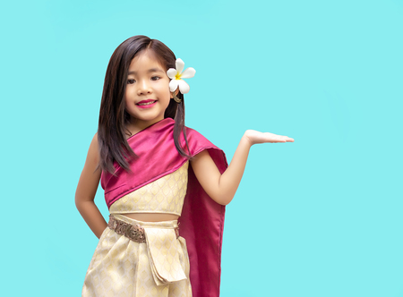 asian Thai kids with Thai tradition dress. Asian girl open hand action for present or suggestion with hand. (Include clipping path)の写真素材