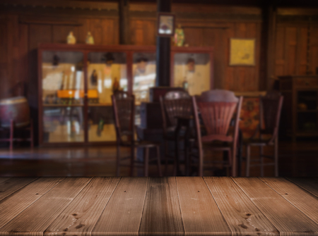 old wood table top with blurred vintage living room with wood decoration Thai Style