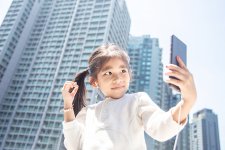 young kid use smart phone to communication with online communication in digital litaracy concept in urban city lifestyle.の写真素材