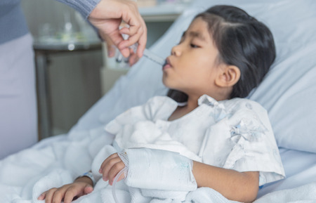 Doctor heal asian kid injection needle medicine in hosital clinic room. Virus flue epidemic situation medicine healthy concept.の写真素材