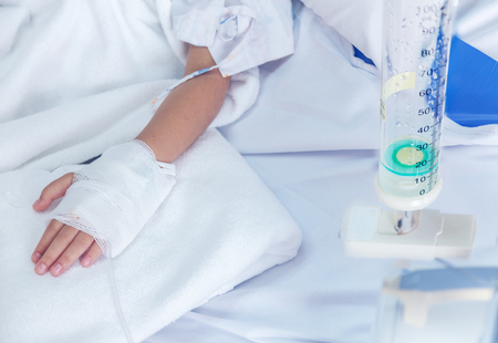 clinic heal kid Fluids Intravenous to blood vein in hosital room. Virus flue epidemic situation medicine healthy concept.の写真素材
