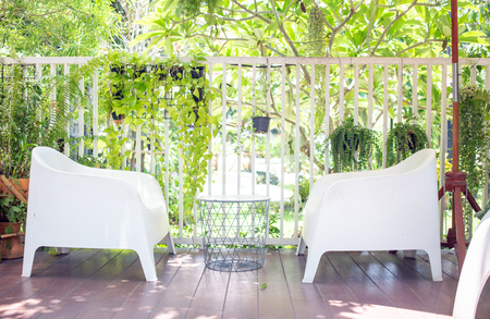 Green seat in garden on sunny day. Relax with nature wallpaper conceptの写真素材
