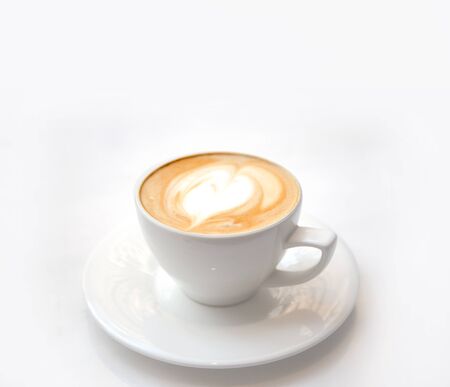 classic late art on white ceramic coffee cup on white background with copy spaceの写真素材
