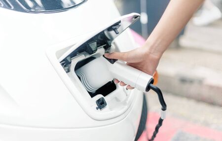 lady hand charge electric power ev car in hi technology transportation in future